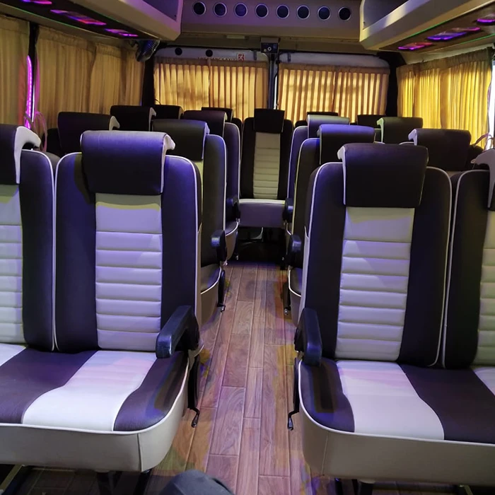 Push back interior seats of an 18 seater tempo traveller for comfortable group travel in Coimbatore